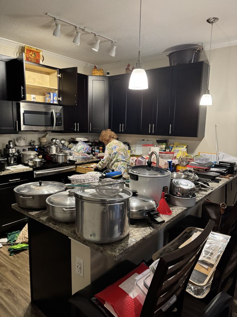 Kitchen cookware and countertop items to be cleared.