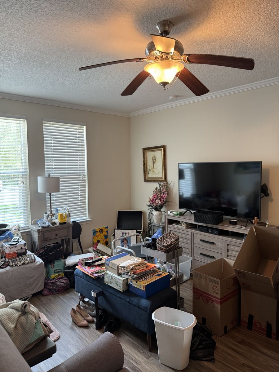 Living room furniture and household contents before removal.